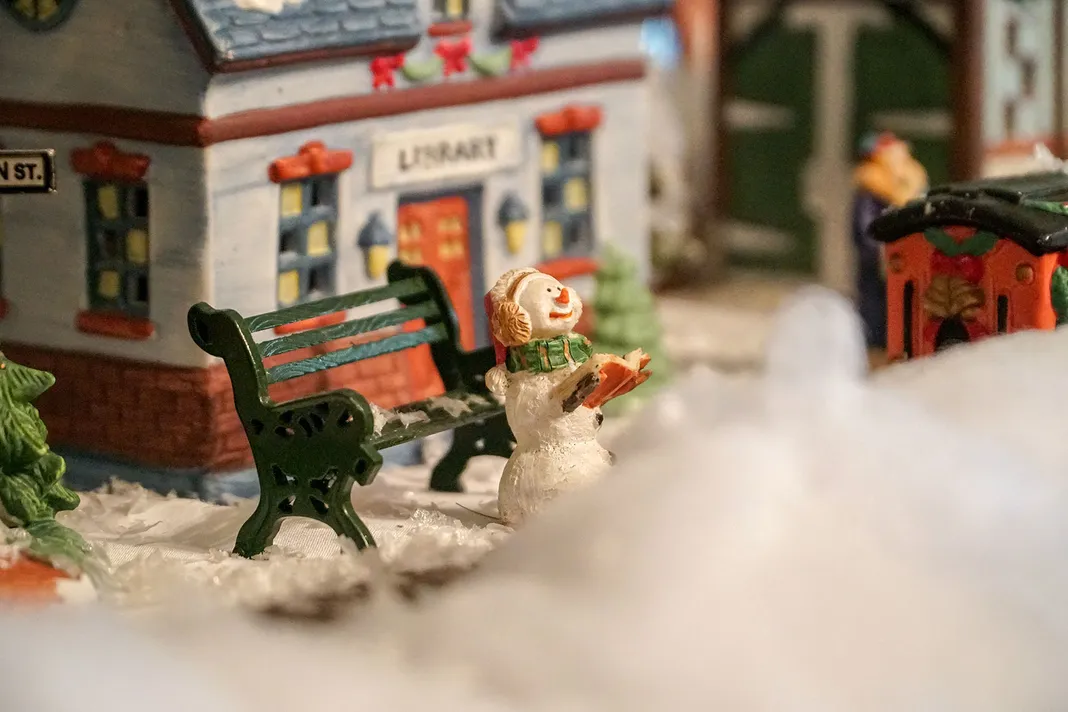 Miniature snowman in a miniature Christmas village