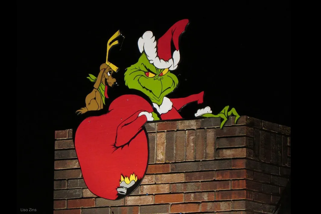 The Grinch and Max cartoon in a chimney