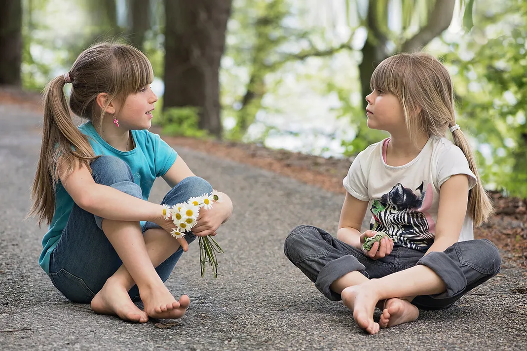 Girls Sitting on pavement