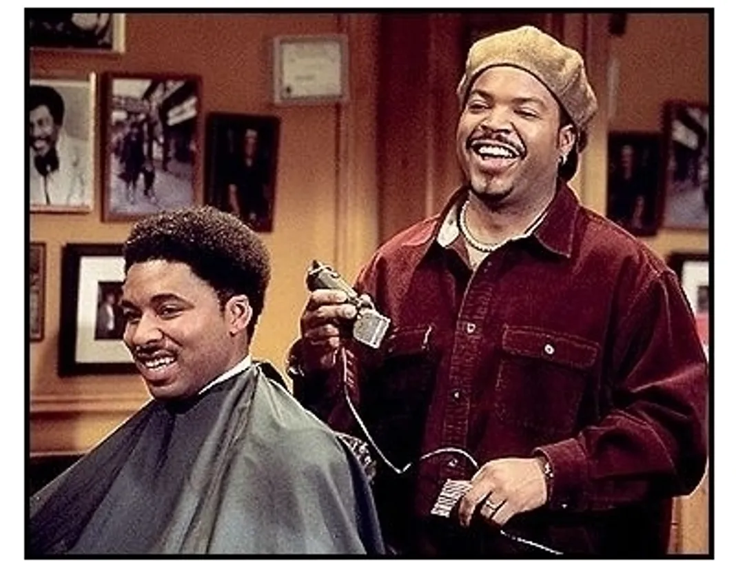 Barbershop movie still: Ice Cube as Calvin cutting up while cutting hair in Barbershop