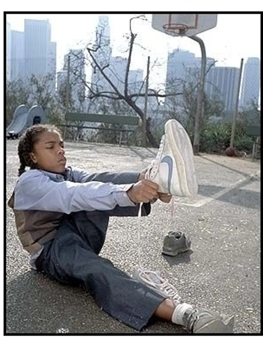 Like Mike movie still: Calvin (Lil Bow Wow) tries on an old pair of sneakers--which turn out to have some special powers